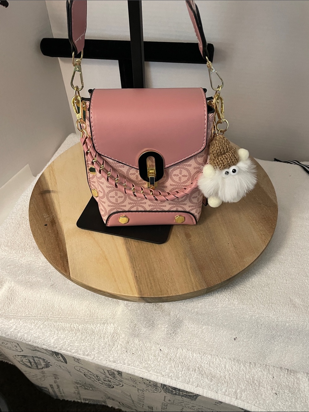 Compact Pink Crossbody Bag with Braided Detail and Charm